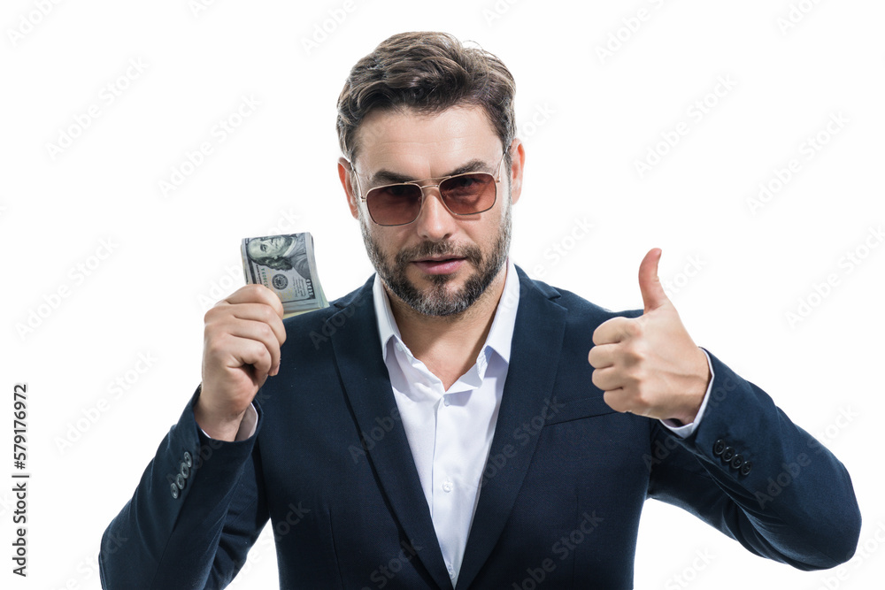 Good payment. Handsome business man holding money isolated over grey studio. Money in dollar banknotes. Pile of cash, finance, investment and money saving. Good payment. Handsome business man holding money isolated over grey studio. Money in dollar banknotes. Pile of cash, finance, investment and money saving.