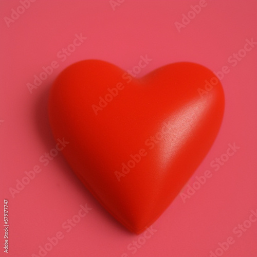 red heart in 3D style on an pink background. A simple image for a graphical user interface.