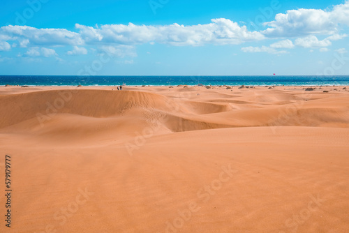 Scenic view of Maspalomas sand dunes desert and seascape with cloudy sky at Gran Canaria