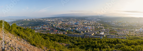 Beautiful wide panorama of the city. Morning cityscape. Top view of buildings and streets. Residential urban areas at sunrise. City of Petropavlovsk-Kamchatsky, Kamchatka Krai, Far East of Russia.
