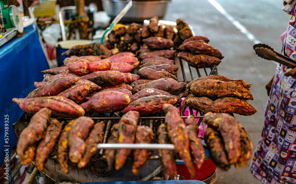 Roasted yam on a charcoal stove for sale in Bang Nam Phueng Floating Market, Thailand