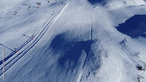 Snowy mountain hut in Tirol region in Austrian Alps Hochfugen drone flyover the mountains and ski-slope and ski-lifts photo