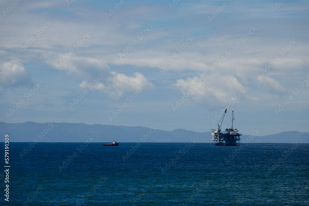 California coast with an offshore oil rig and cranes