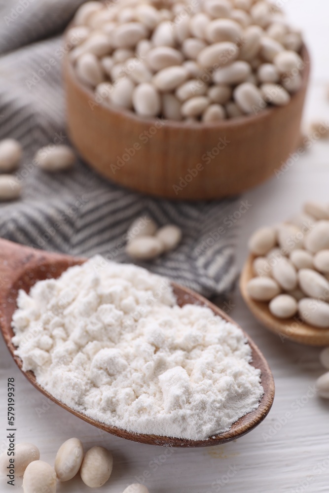 Kidney bean flour and seeds on white wooden table, closeup Kidney bean flour and seeds on white wooden table, closeup
