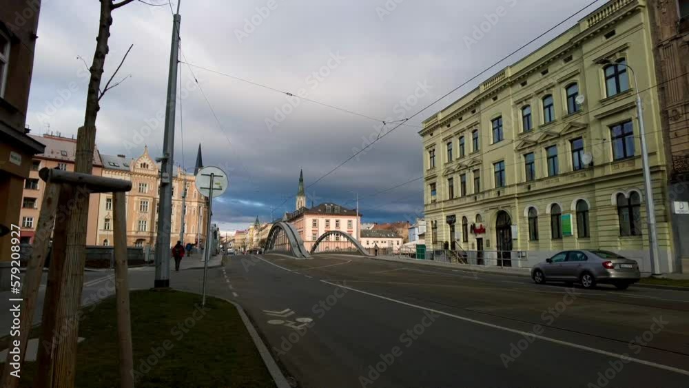 Shot of almost empty two way road in Olomouc, Czech Republic on a cloudy morning with locals passing by. Shot of almost empty two way road in Olomouc, Czech Republic on a cloudy morning with locals passing by.