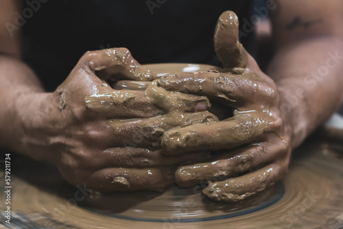 hands working the mud