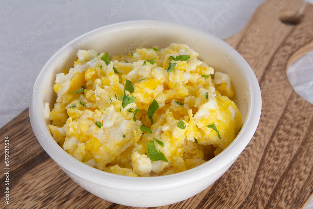 Wholesome Scrambled Eggs with Fresh Seasonings in Bowl Wholesome Scrambled Eggs with Fresh Seasonings in Bowl