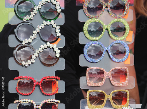Large glittery sun glasses for sale at the fair. WorldPride, Mardi Gras Fair Day. 