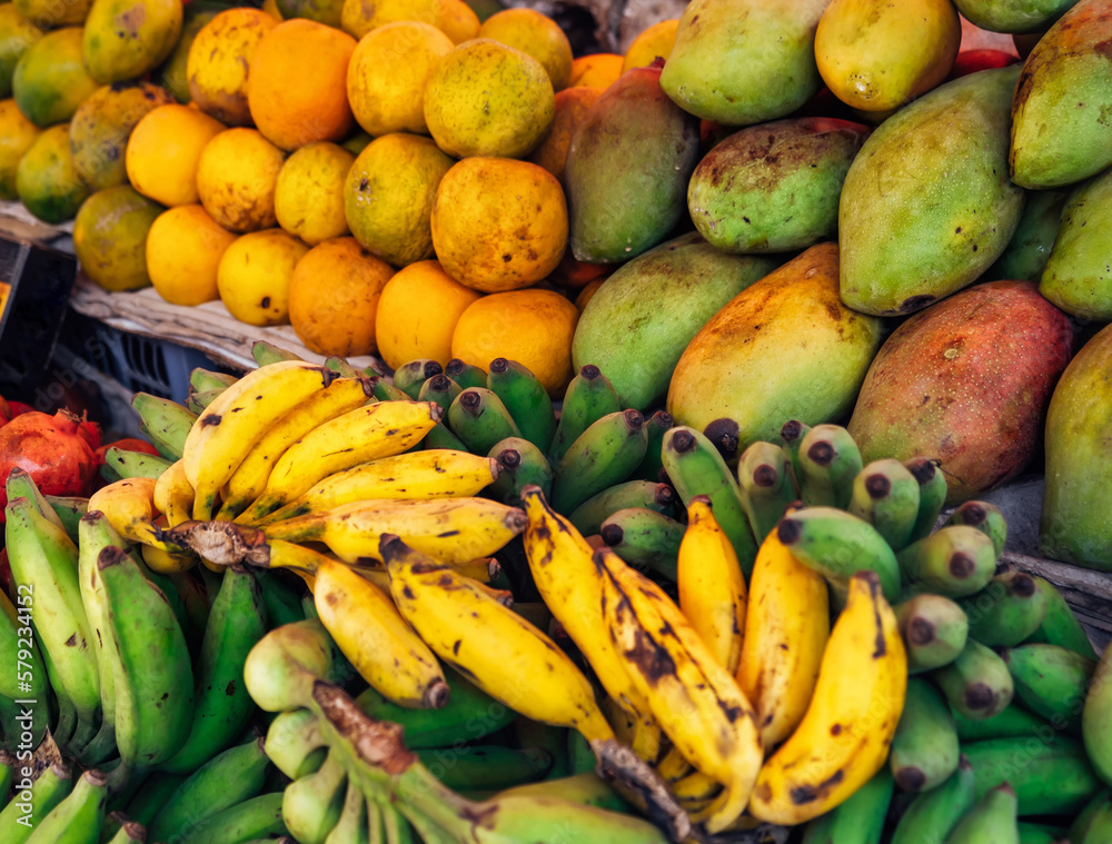 Lots of different ripe fruits on the market in Asia. Fruity multicolored background Lots of different ripe fruits on the market in Asia. Fruity multicolored background