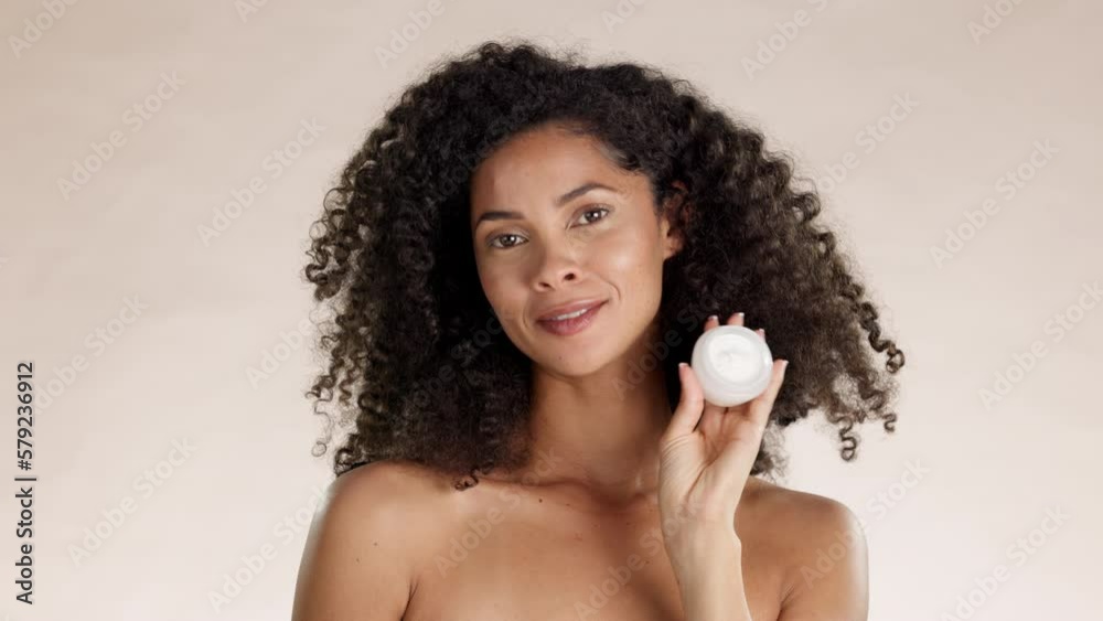 Face cream, skincare and black woman in studio for facial, mask or moisturizing wellness on brown background. Portrait, container and beauty product by happy model showing sunscreen while isolated Face cream, skincare and black woman in studio for facial, mask or moisturizing wellness on brown background. Portrait, container and beauty product by happy model showing sunscreen while isolated