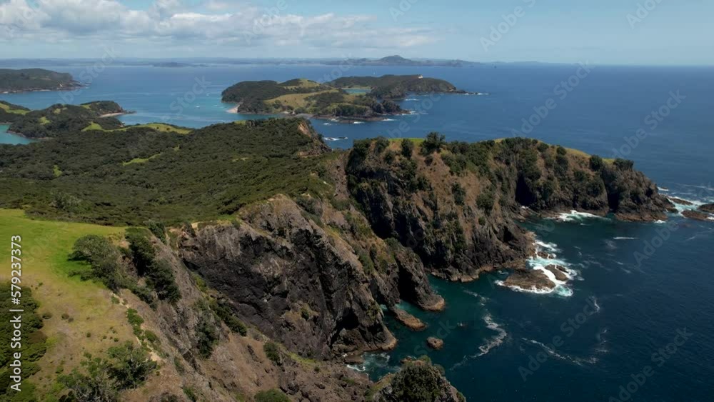 Beautiful paradise island with massive cliffs, summer sunny day, Urupukapuka Island, New Zealand - aerial pull back Beautiful paradise island with massive cliffs, summer sunny day, Urupukapuka Island, New Zealand - aerial pull back