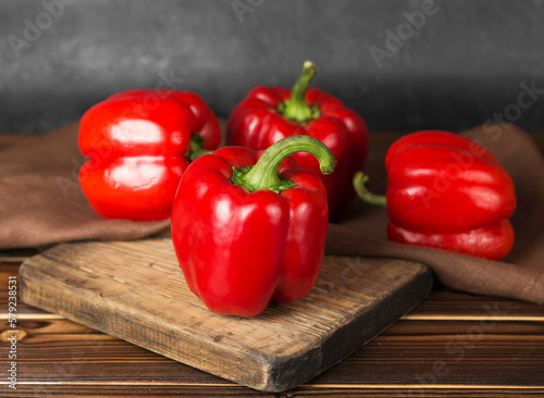red fresh ripe paprika on wooden board
