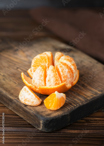 peeled tangerine on a wooden table
