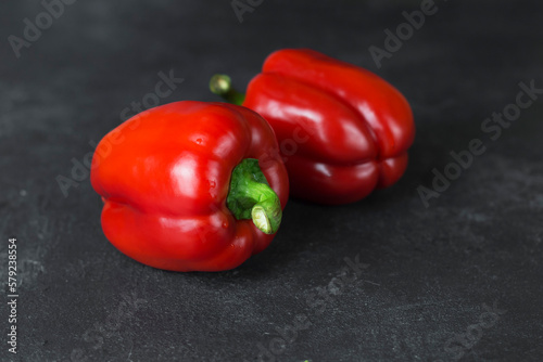 red fresh ripe paprika on wooden board