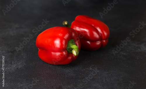 red fresh ripe paprika on wooden board