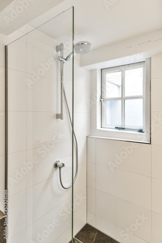 Фотография a bathroom with a shower and window in the back wall, which has been replaced to