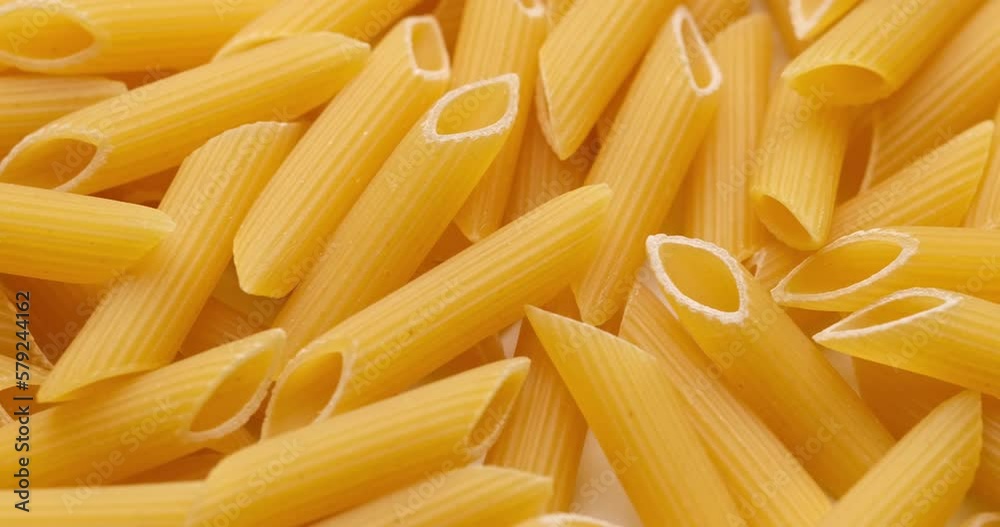 pasta backgroud - macro view of Dry Authentic Italian penne pasta backgroud - macro view of Dry Authentic Italian penne