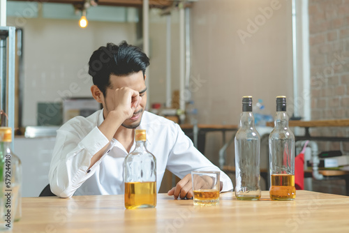 Alcoholism concept. Young man drinking alcohol too much.