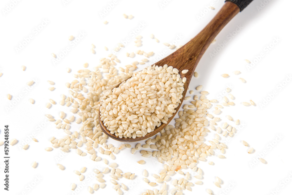 white sesame seeds in wooden spoon isolated on white background. white sesame seeds in wooden spoon isolated on white background.