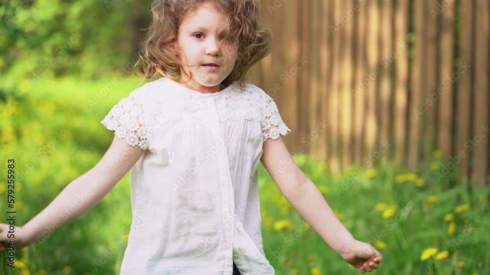 Curly little girl with dandelions flowers Curly little girl with dandelions flowers