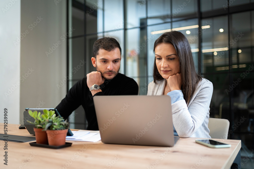 Teamwork using laptop in office