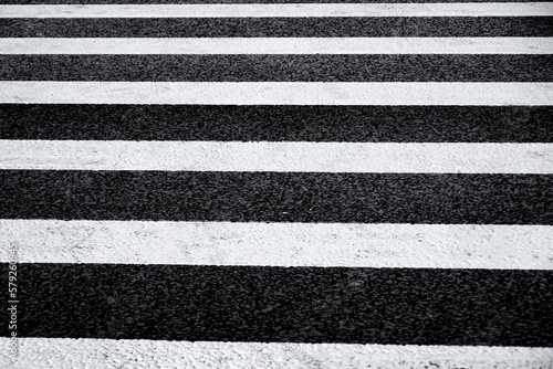 Crosswalk surface background,top view. pedestrian crossing, white stripes on black asphalt, zebra crossing