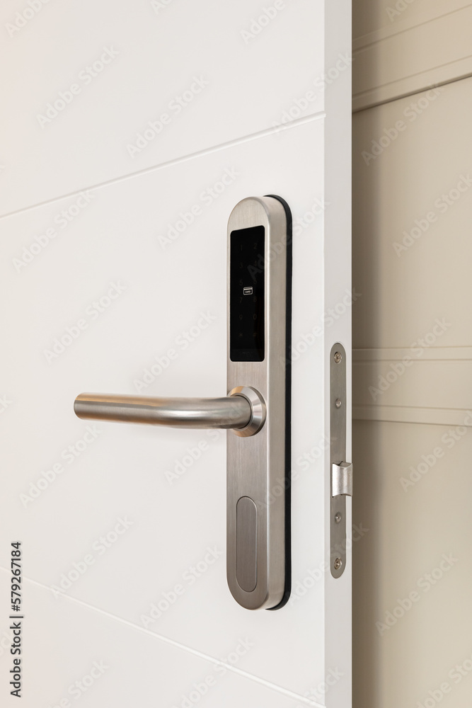 Close-up of doorknob with a digital lock on white door at the entrance to a hotel room. Concept of a modern protective system and technology to make life easier Close-up of doorknob with a digital lock on white door at the entrance to a hotel room. Concept of a modern protective system and technology to make life easier