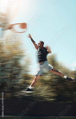 Basketball, sports and goals with man and jump in park court training for fitness, health and workout. Energy, action and exercise with athlete in playing game for competition, wellness and winning