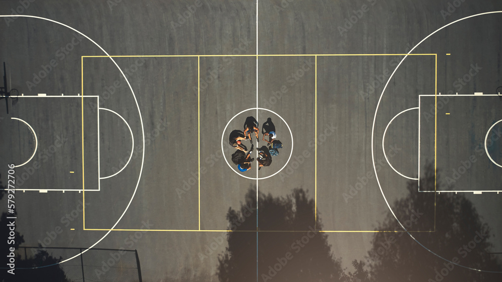 Top view, basketball court or men in training break circle for game strategy, college match planning or target goal collaboration. Basketball players, sports team or community fitness in workout rest Top view, basketball court or men in training break circle for game strategy, college match planning or target goal collaboration. Basketball players, sports team or community fitness in workout rest