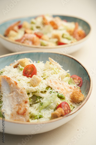 Traditional caesar salad with shrimp and chicken