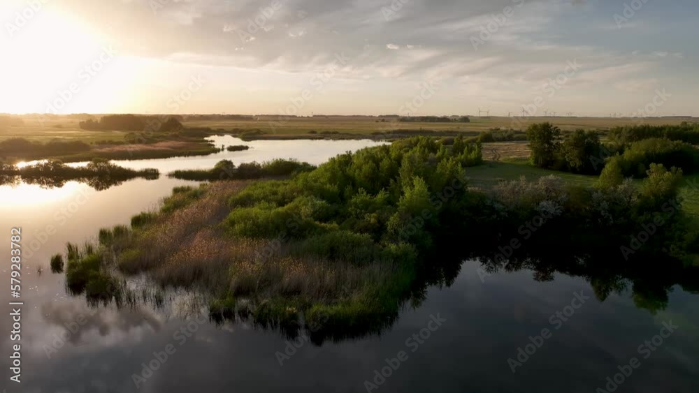 In the reflection of the small steppe lake flashes the glint of the setting sun. Evening time. In the reflection of the small steppe lake flashes the glint of the setting sun. Evening time.