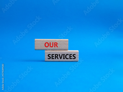 Our services symbol. Concept words Our services on wooden blocks. Beautiful blue background. Business and Our services concept. Copy space.
