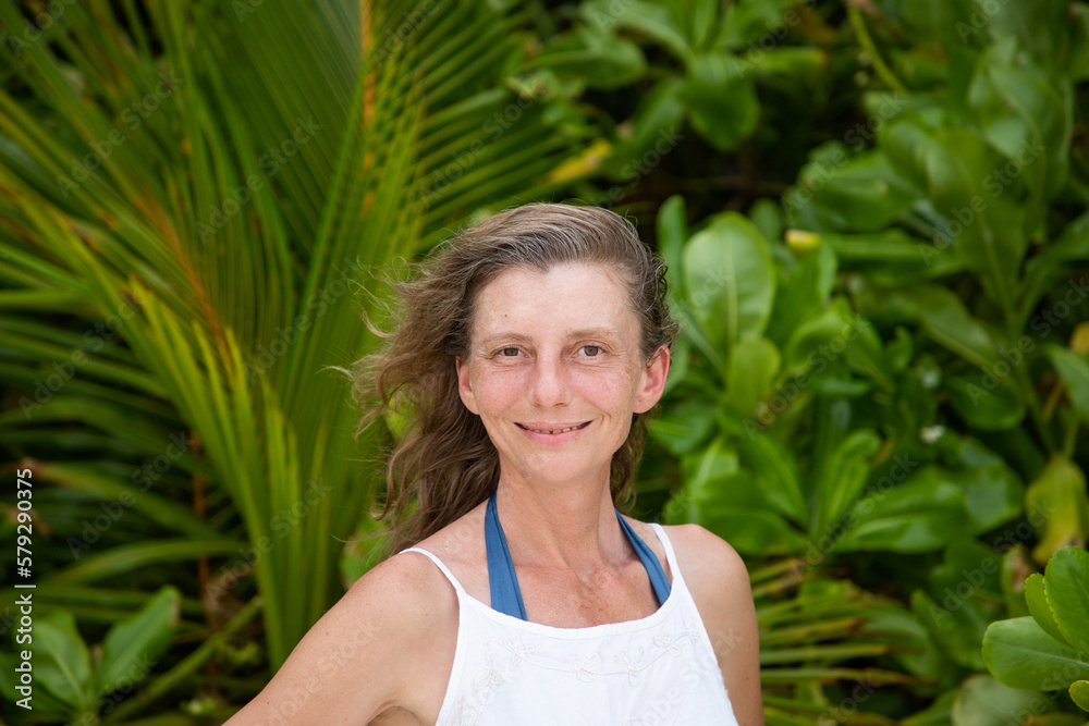 woman portrait and lush tropical greenery woman portrait and lush tropical greenery