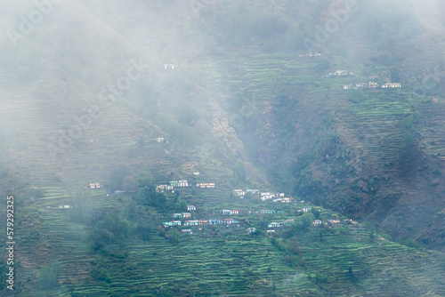 A beautiful Himalayan village covered in mist and fog in the mountains around Munsyari in Uttarakhand.