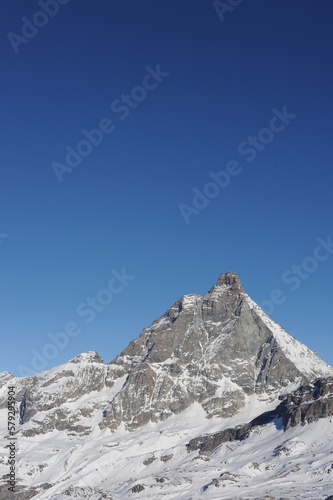 Matterhorn peak in Zermatt in winter with snow and blue sky on a sunny day in the Alps, Switzerland, Europe