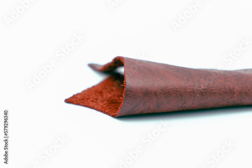 Red leather is folded on a white background