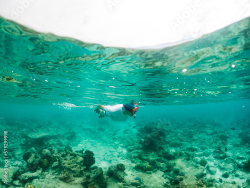 woman snorkeling in clear tropical sea