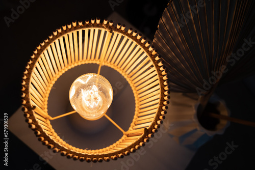 a wooden lamp shines on the table