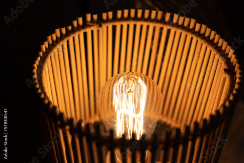 a wooden lamp shines on the table