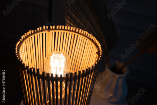 a wooden lamp shines on the table