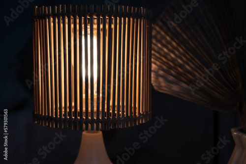 a wooden lamp shines on the table