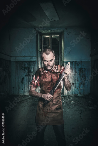 serial killer with machete and blood stained apron photo
