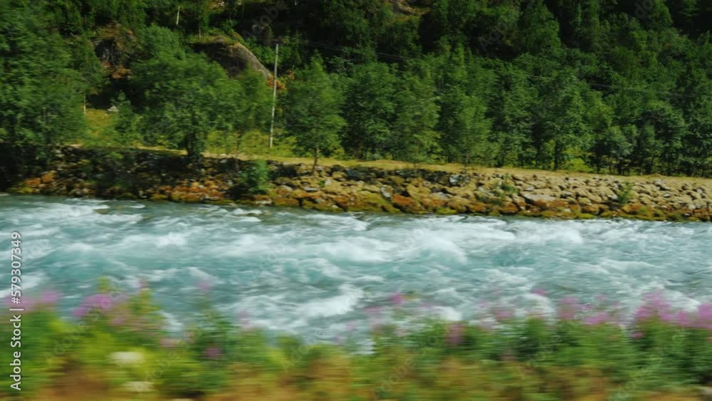 Ride along a turbulent mountain river in the spring. Travelling in Norway Ride along a turbulent mountain river in the spring. Travelling in Norway