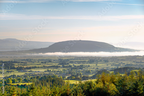 N.E. to Knocknarea Mt. beyond Ballysadare Bay  Sligo  Ireland. Early morning. Prehistoric stone cairn known as Queen Maeves Grave visible on summit