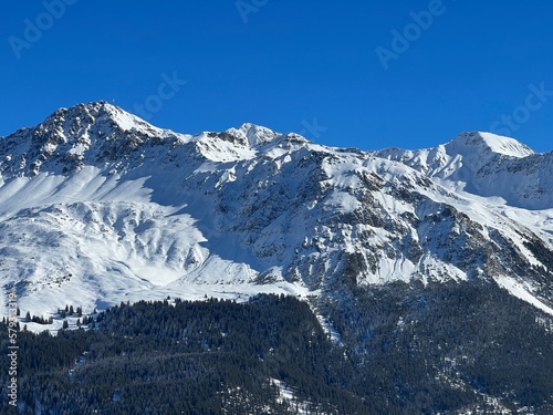 Beautiful sunlit and snow-capped alpine peaks above the Swiss tourist sports-recreational winter resorts of Valbella and Lenzerheide in the Swiss Alps - Canton of Grisons, Switzerland (Schweiz) © Mario