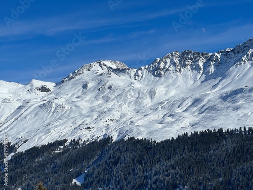 Beautiful sunlit and snow-capped alpine peaks above the Swiss tourist sports-recreational winter resorts of Valbella and Lenzerheide in the Swiss Alps - Canton of Grisons  Switzerland  Schweiz 