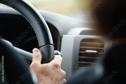 Driving a car - close-up on steering wheel