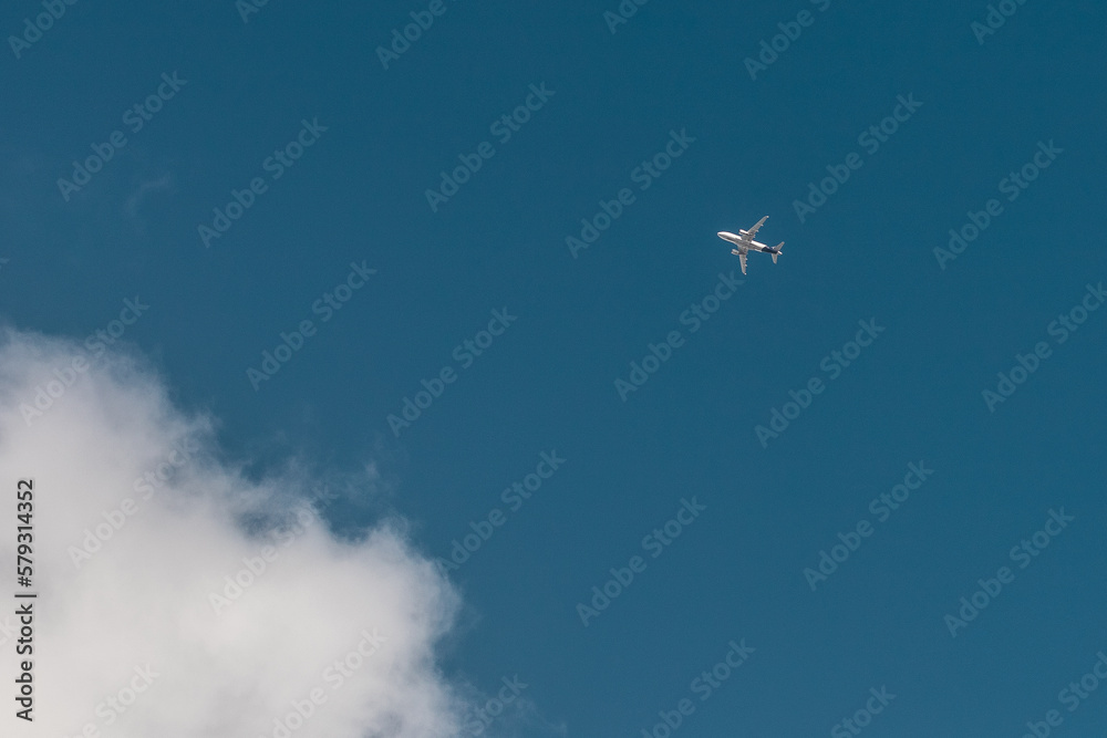 Plane in the blue sky and small cloud