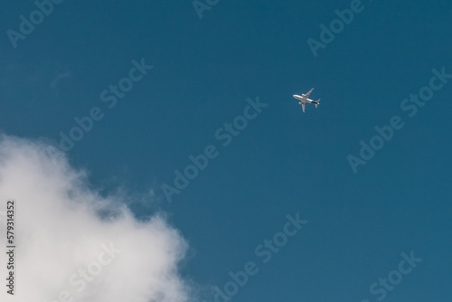 Plane in the blue sky and small cloud