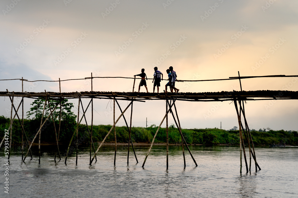 Rural children on a bamboo bridge made in Cam Dong village, Quang Nam province, Vietnam